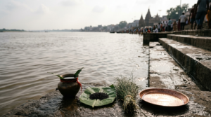 Mahalaya Amavasya 2026 tarpanam offering of water and black sesame at a river ghat in afternoon light
